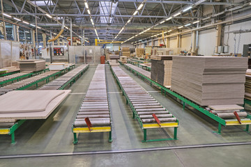 Laying chipboard for processing and production of furniture in a woodworking enterprise.