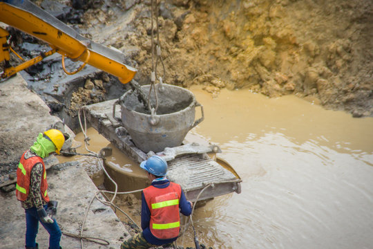 Wet concrete pour or pump from the concrete lorry into the bore pile casing. Bored piles are piles where the removal of spoil forms a hole for a reinforced concrete pile which is poured in situ.