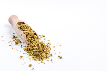 oregano herb in wooden scoop isolated on white background with copy space added