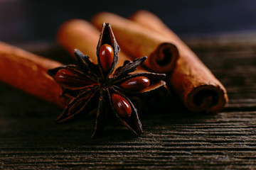 Spices sticks cinnamon and star anise on the old table. Rustic dark background, aroma close-up, macro.