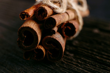 Spices sticks cinnamon on the old table. Rustic background, aroma close-up.