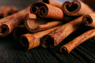 Spices sticks cinnamon on the old table. Rustic background, aroma close-up.