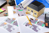 Drawings, layout of the house, documents, calculator on the desktop in the office. Engineering, construction, business.