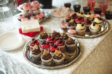 beautiful delicious cakes. confectionery curry at a festive party. many sweet muffins on a tray