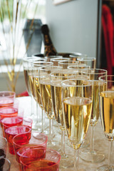 buffet table with snacks, cakes, drinks and champagne. slide champagne on the background