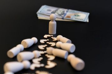 Concept Move to the break. concept all for money for wealth. Wooden men and dollars on a black background
