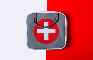 First aid kit on color white red background,flat lay, top view