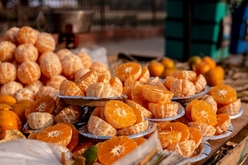 Skinned Oranges cut into pieces for street vending. 