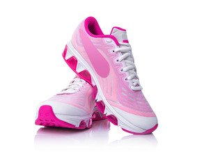 Pink sport shoes isolated on white background.