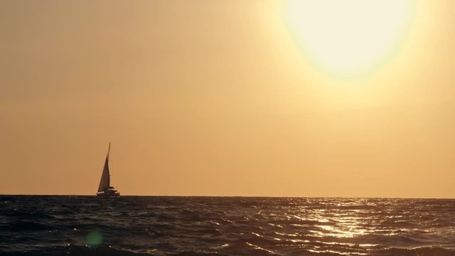Sailing yacht on the background of the sunset. Yacht silhouette in the ocean at sunset. Yacht tourism, a romantic trip on a luxury yacht during a sea sunset.