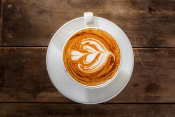 hot cappuccino on the woodden table