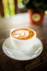 hot cappuccino on the woodden table