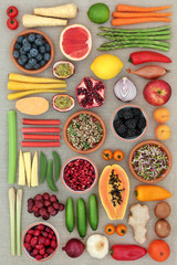 Super food concept for healthy eating  with fruit, vegetables and spice with foods high in antioxidants, anthocyanins, dietary fibre and vitamins. Flat lay.