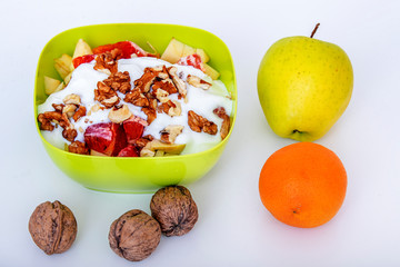 Fruit bowl with sliced apples oranges and nuts