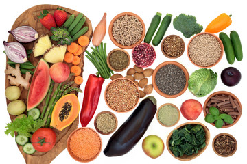 Alkaline health food for ph balance with vegetables, fruit, nuts, seeds, herbs, whole wheat pasta & grains. High in omega 3, antioxidants, anthocyanins, fibre, minerals & vitamins. Top view on white.