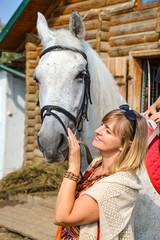 Obraz premium woman with a horse on a farm