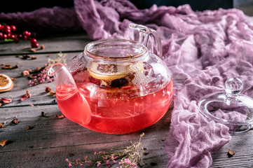 Hot red fruit tea in glass teapot
