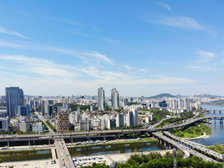Obraz premium Aerial view cityscape of Seoul, South Korea. Drone View of Seoul with river and mountain. Seoul downtown city skyline, Aerial view of Seoul, South Korea, 08/20.2018