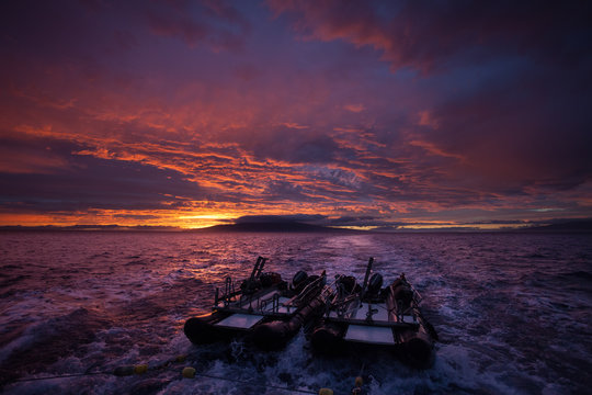 Dark purple sunset colors over an ocean landscape © DaiMar