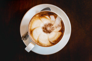 hot cappuccino on the woodden table