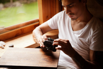 Young man adjusting camera 