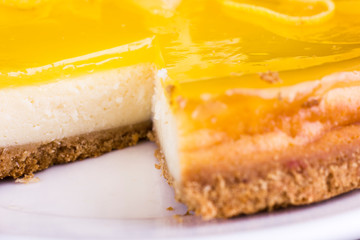 Lemon cheesecake decorated with lemon zest close up. Selective focus