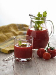fresh tomato juice with celery. various options on a wooden table