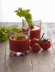 fresh tomato juice with celery. various options on a wooden table