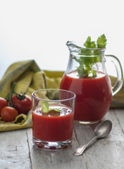fresh tomato juice with celery. various options on a wooden table