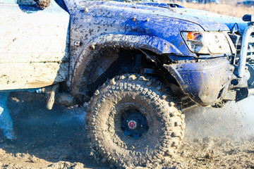 Fototapeta na wymiar Ukrainian offroad competition in the city of Kamyanets Podilsky. Swamp and mud on cars. Produce large puddles