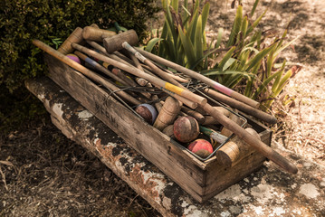 Outdoor croquet game - vintage equipment in a wooden box.
