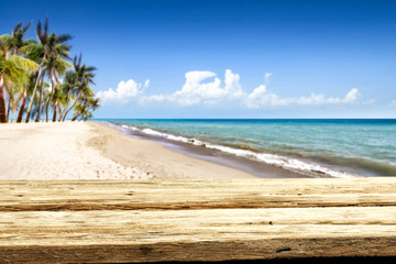 Wooden desk of free space and summer time on beach. 