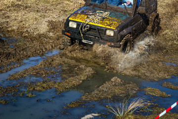 Obraz premium Ukrainian offroad competition in the city of Kamyanets Podilsky. Swamp and mud on cars. Produce large puddles