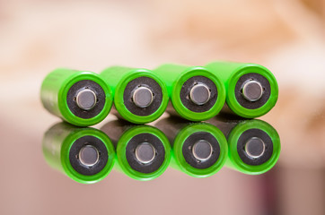 Close-up of green alkaline batteries. Close up colorful rows of AA batteries energy background...
