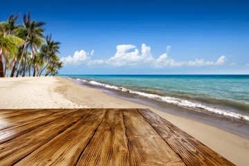 Wooden desk of free space and summer time on beach. 