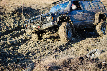 Ukrainian offroad competition in the city of Kamyanets Podilsky. Swamp and mud on cars. Produce large puddles © Yaroslav