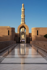 Unrecognizable believers enter the Great Mosque of Muscat (Oman)