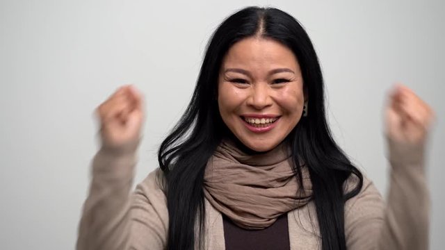Portrait of a cheerful Asian woman showing her happiness