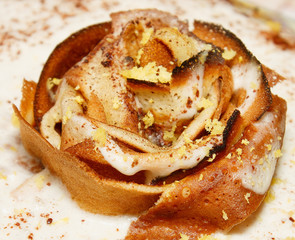 Rose of pancakes on the cake with cream close-up. Homemade delicious pastries.- Image