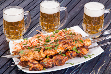 delicious grilled lamb shashlik with beer on the table