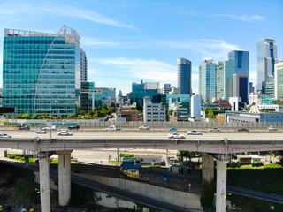 Aerial view of car driving on the bridge highway in Seoul, South of Korea. Side view of highway with cars going in both side. Busy traffic road next to city building, Seoul, South Korea, 08/20/2018