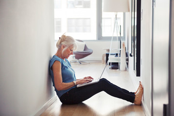 Senior woman using laptop at home 