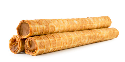 Waffle tubes with condensed milk on a white background. Isolated.