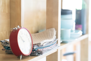 Vintage alarm clock on the shelf with dishes