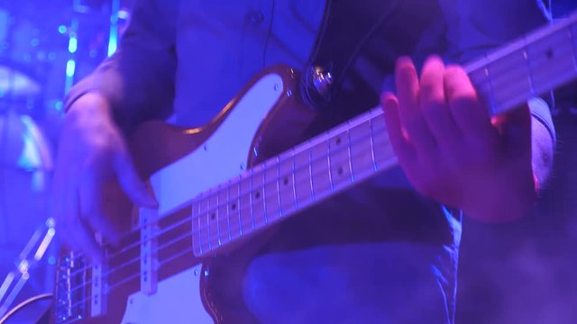 Fingerboard of electric guitar with fingers of virtuoso. Electro guitar playing closeup. Performer, player, instrumentalist playing guitar at concert. Masterclass for musically talented people