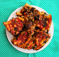 A piece of macaroni with mushrooms and tomato sauce