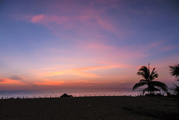 Romantic pink orange and blue sunset over beach in Thailand