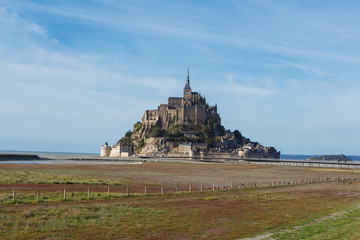 Fototapeta na wymiar Mont Saint-Michel at low tide during a sunny day in autumn