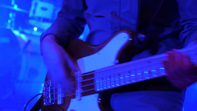 Electro guitar playing closeup. Guitarist with guitar at concert. Performer, player, playing guitar at concert. Fingerboard of electric guitar with fingers of virtuoso at concert. Guitarist background