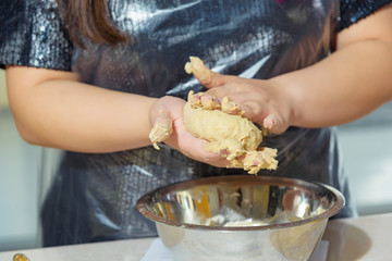 Kneading the dough. Woman's hands. Cooking. Master class. Cooking of the dough. Manicure. Knead dough. Apron. Dough in hand.